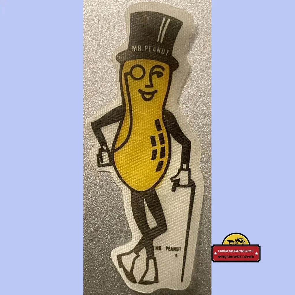 Cartoon peanut mascot with top hat and cane on a vintage peanut cloth sticker