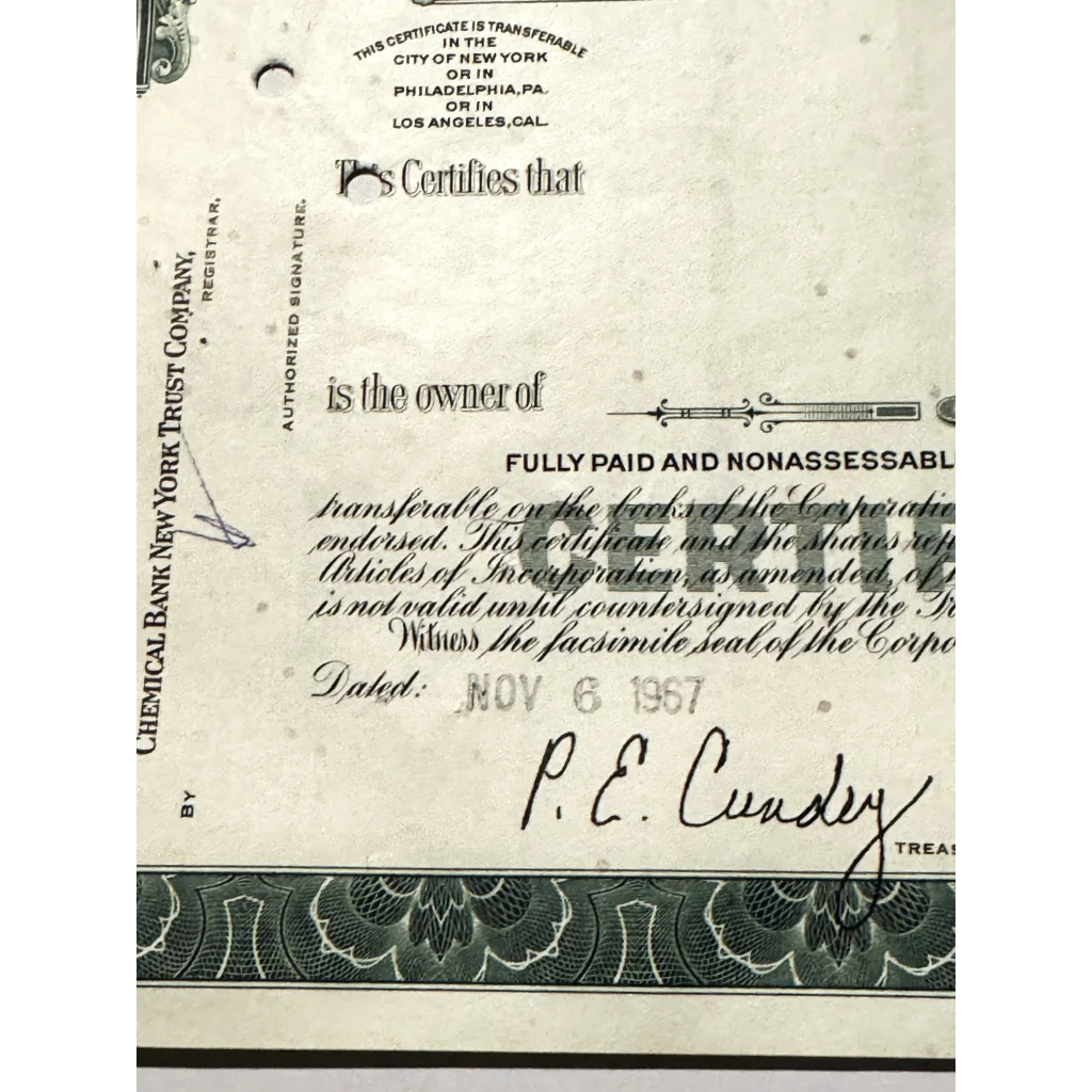 Partial view of a 1957 Atlantic Richfield stock certificate with ornate borders and signature