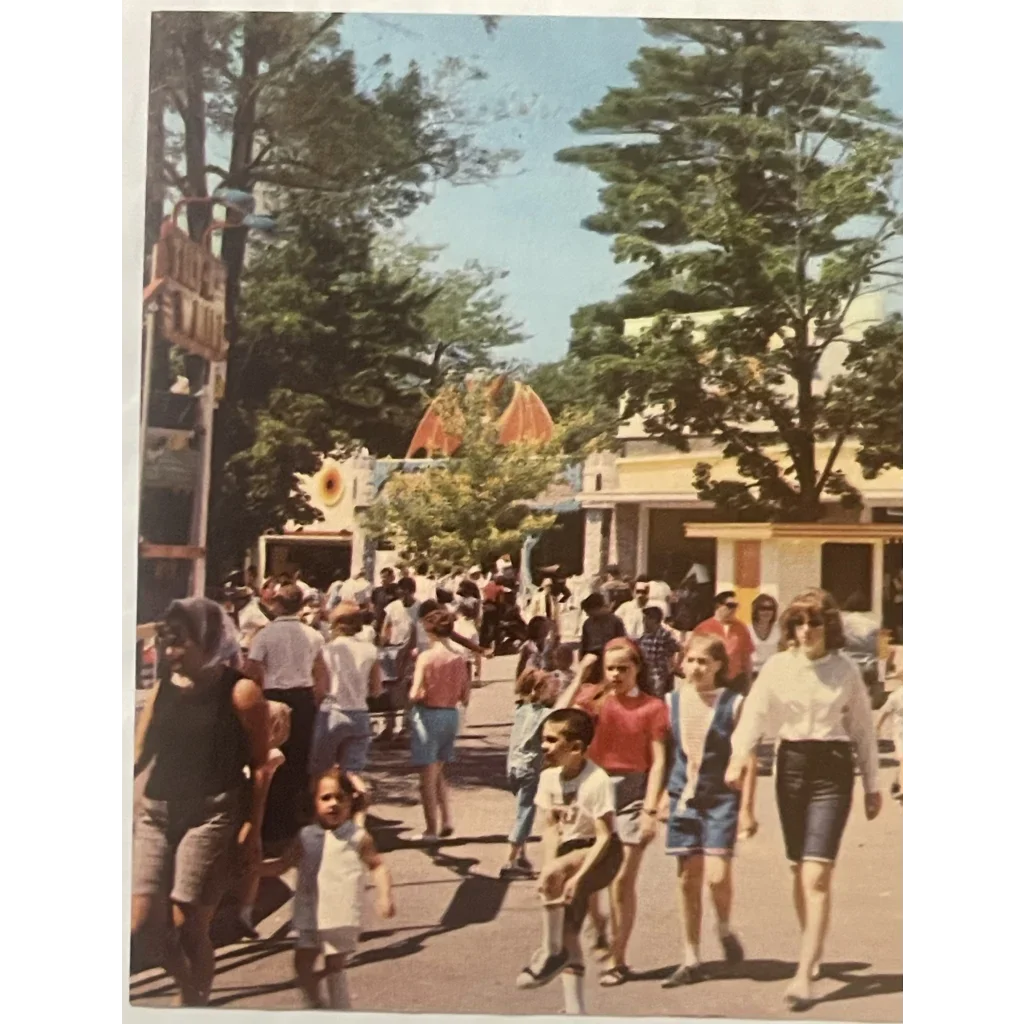 Crowd of people at Canobie Lake Park enjoying a sunny outdoor path