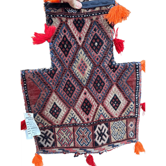 Vintage 1960s Persian Baluch salt bag with geometric patterns and vibrant tassels