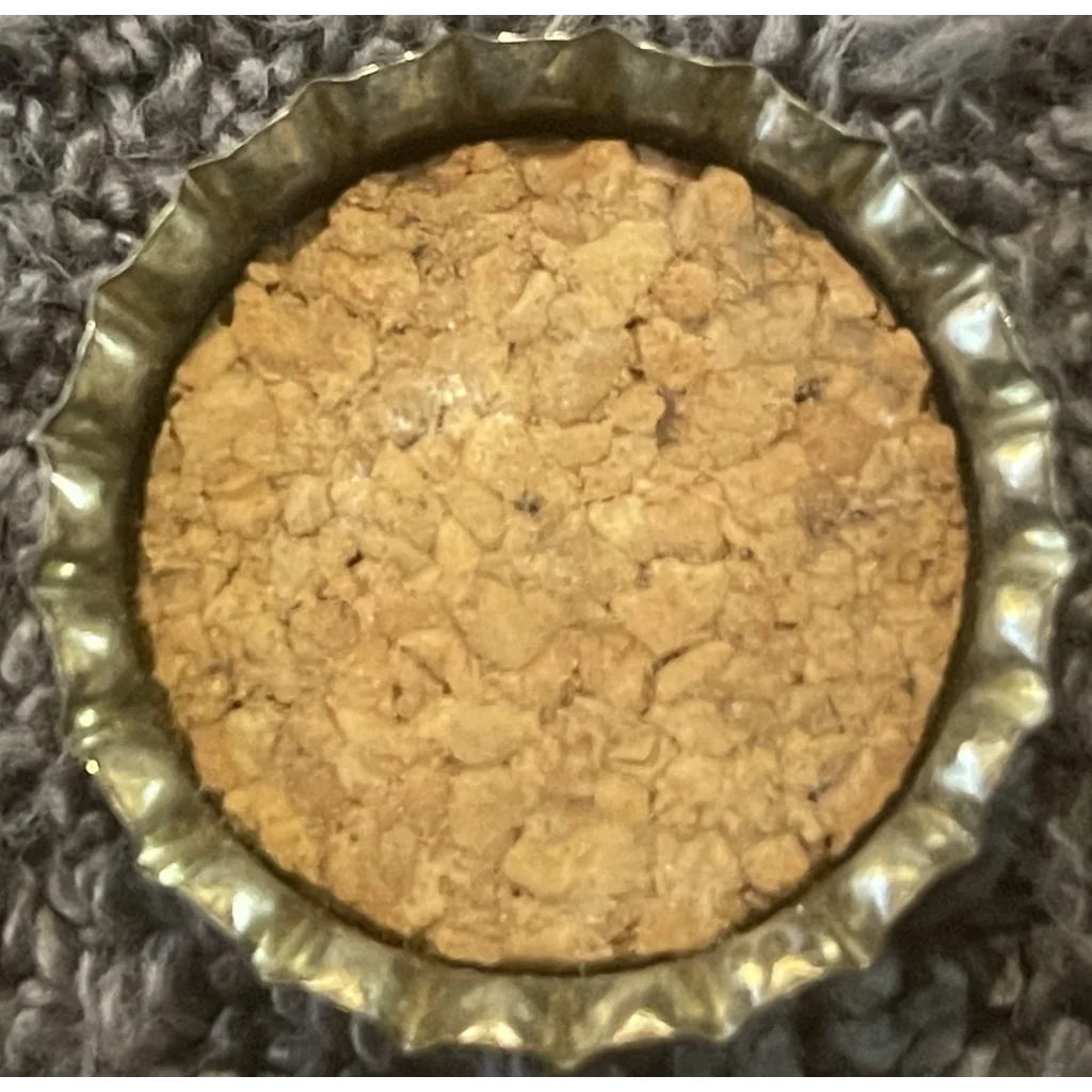 Circular cookie in a Rare 1960s Red Eye Root Beer Cork Bottle Cap with Bull Logo