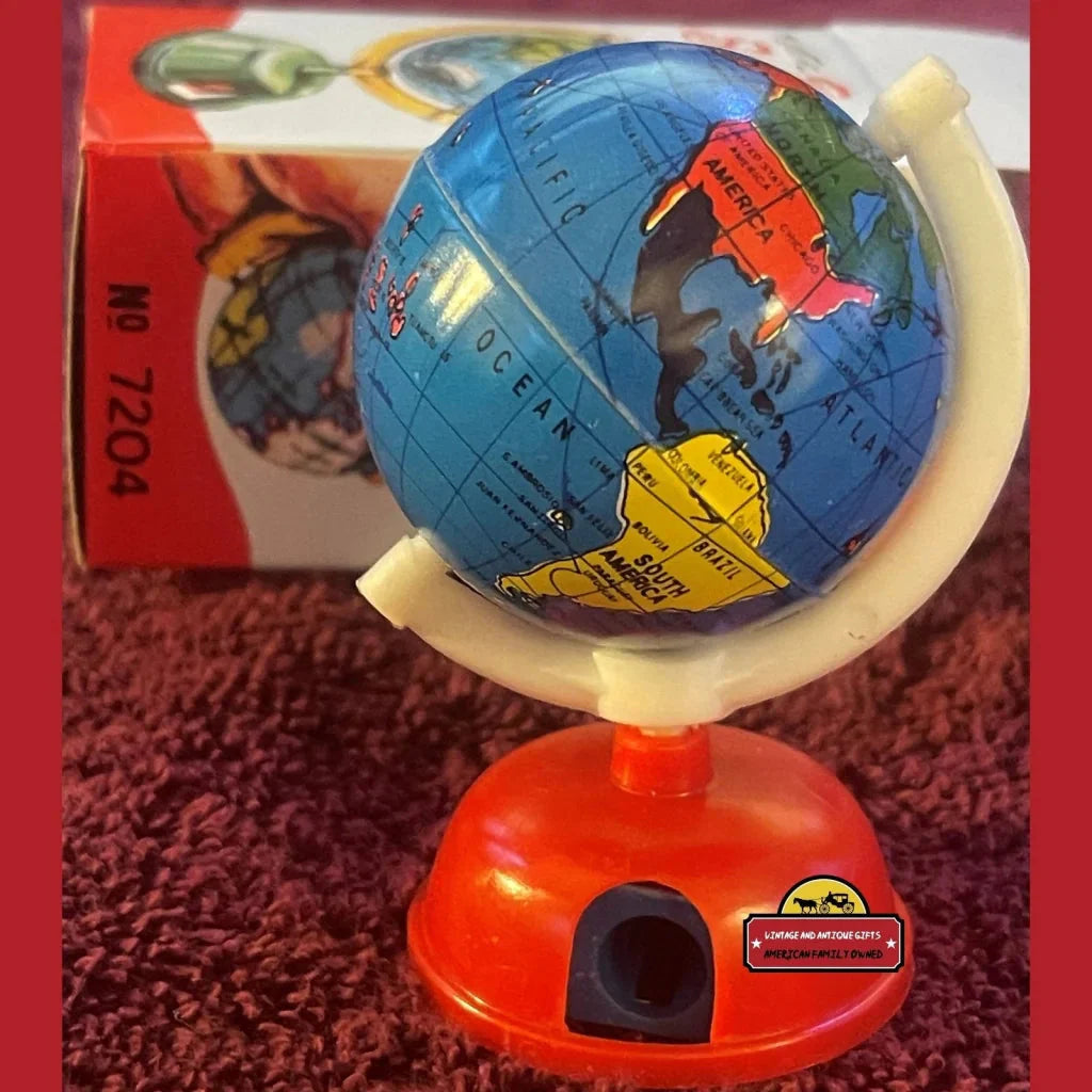 Colorful Globe Pencil Sharpener on orange stand, perfect for vintage charm lovers