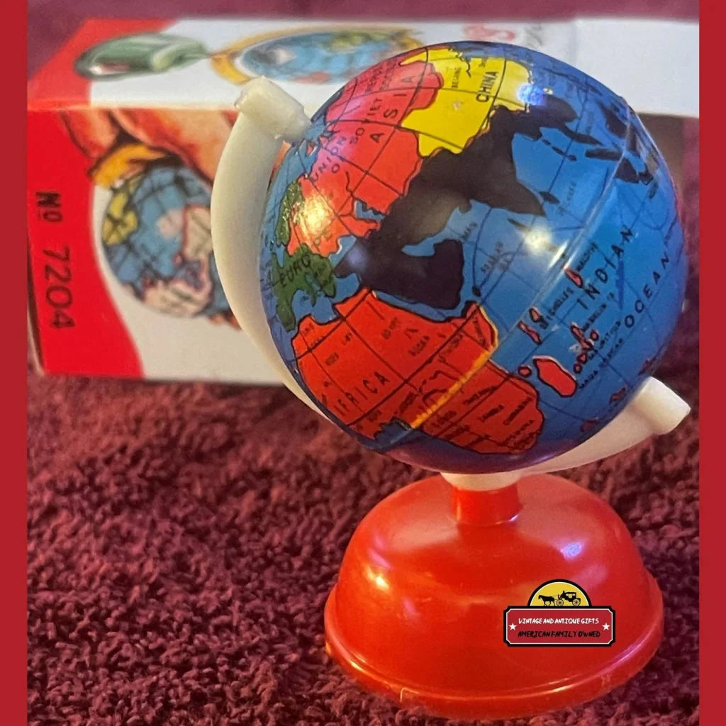 Colorful globe pencil sharpener on red stand from the 1960s, a nostalgic treasure!