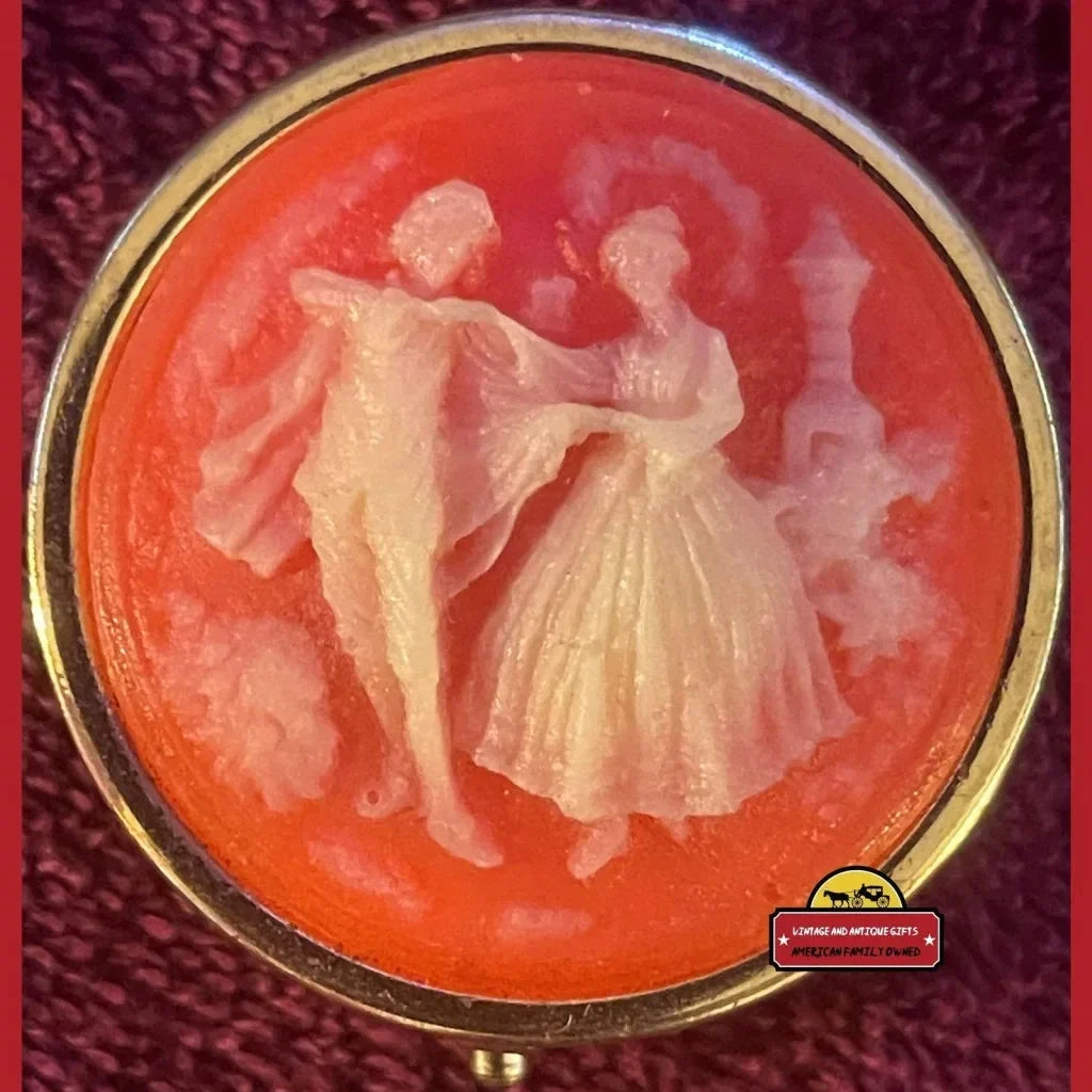 Vintage 1970s cameo brooch of dancing lovers on coral background for collectible tin