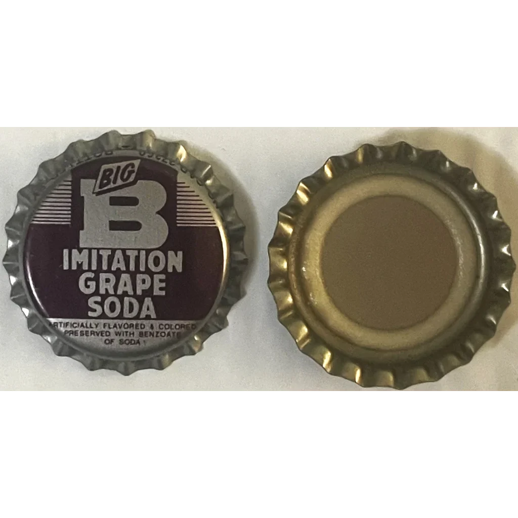 Two bottle caps, one labeled Big B Grape Soda, and a plain gold soda bottle cap