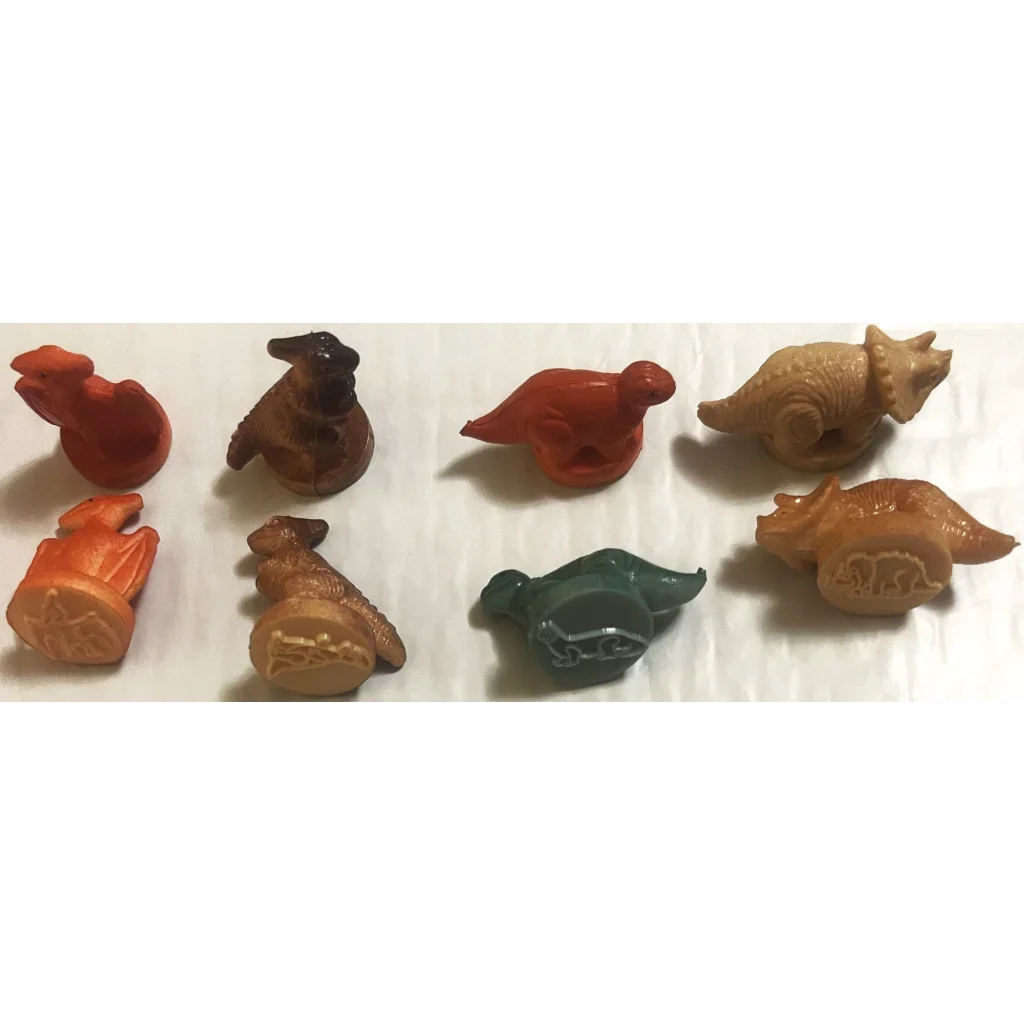 Colorful ceramic animal figurines next to Rare Vintage 1970s Dinosaur Rubber Stamps