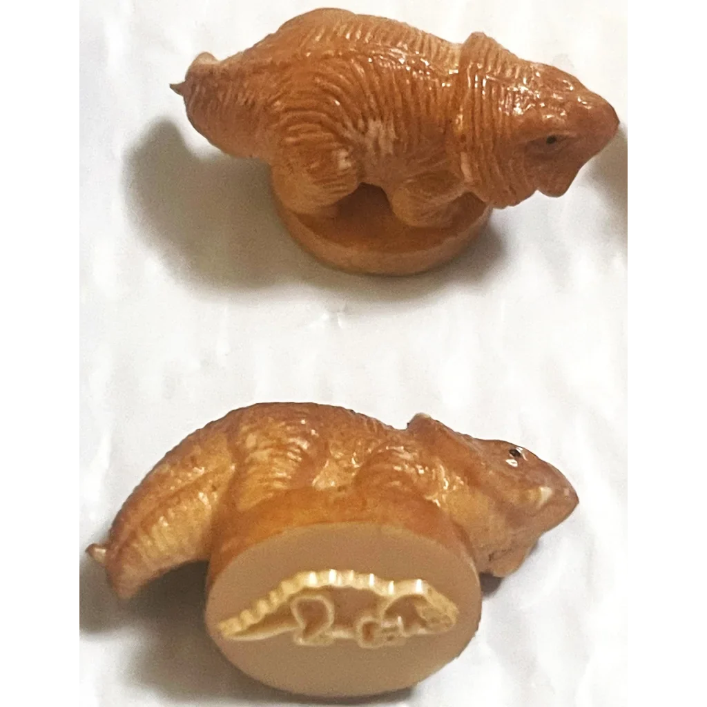 Intricate carved wooden bear figurine next to Rare Vintage 1970s Dinosaur Rubber Stamps