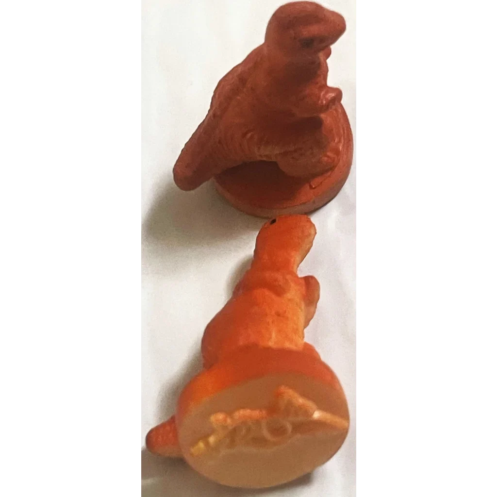 Red clay bird figurine paired with Rare Vintage 1970s Dinosaur Rubber Stamps for collectors