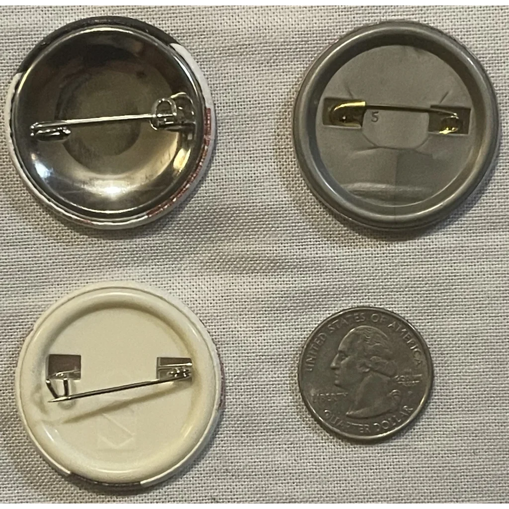 Button pins in assembly next to a quarter, featuring the California Raisin Tin design