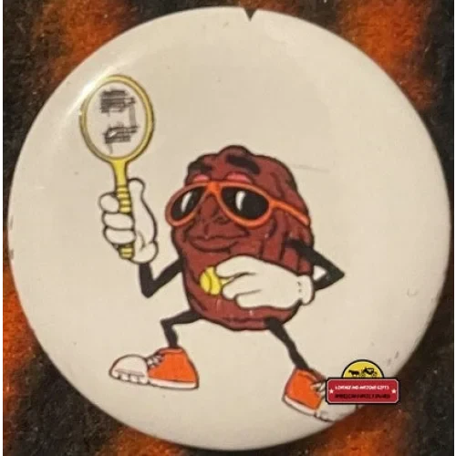 California Raisin character ready to serve with tennis racket, shades, and orange kicks