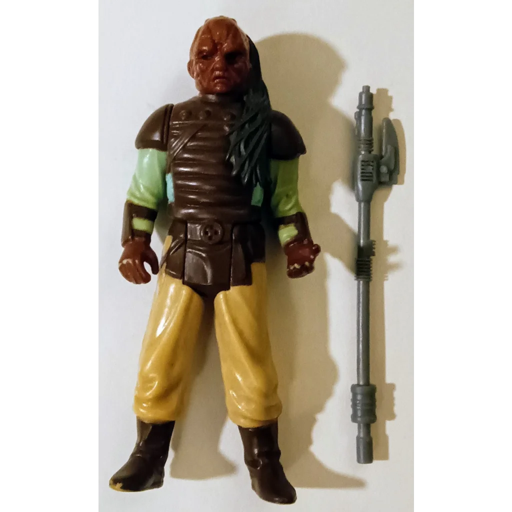 Vintage 1983 Kenner Star Wars action figure Weequay in brown and yellow with green shirt, black boots, and weapon