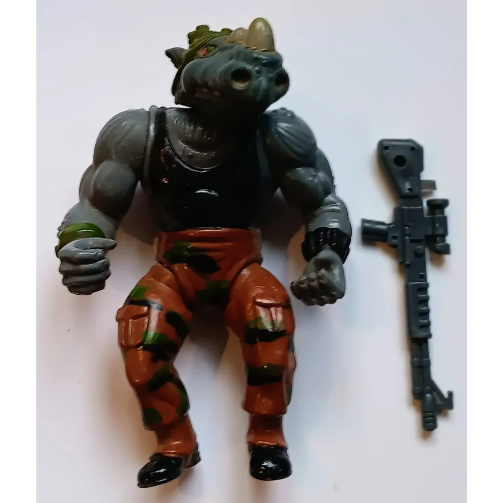 Vintage 1988 TMNT Rocksteady action figure in camo pants, boots, with gun