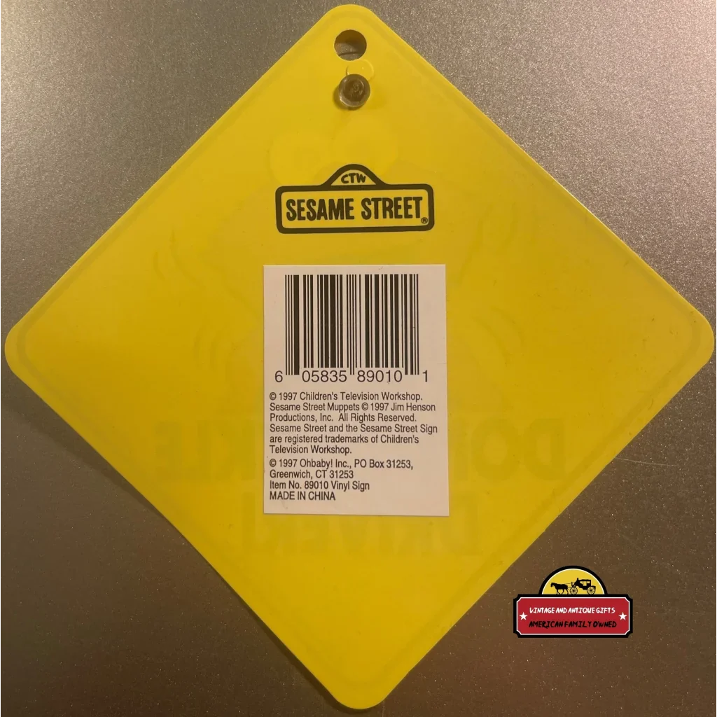 Yellow diamond tag with Sesame Street logo and barcode on Vintage Elmo Window Sign