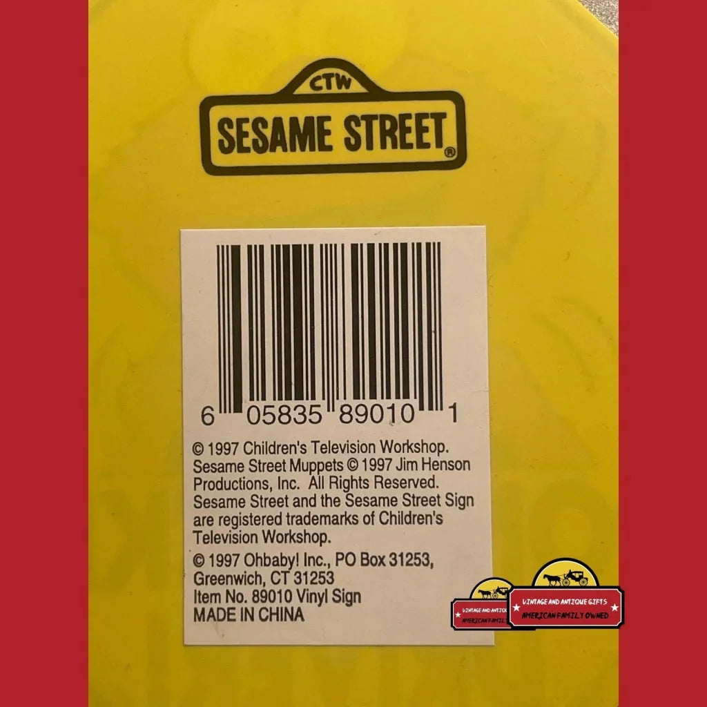 Sesame Street logo and barcode on a yellow surface for Vintage Elmo Window Sign