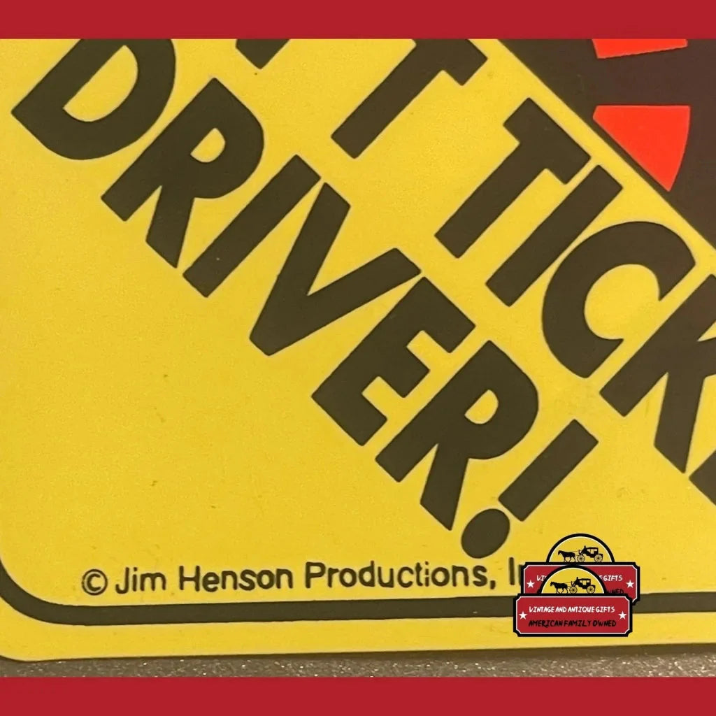 Yellow triangular TICK DRIVER sign on Vintage Sesame Street Elmo Window Sign collectible