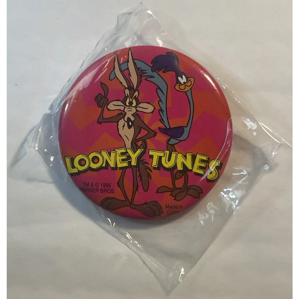 Circular Looney Tunes pin with Roadrunner and Wile E Coyote on a red background