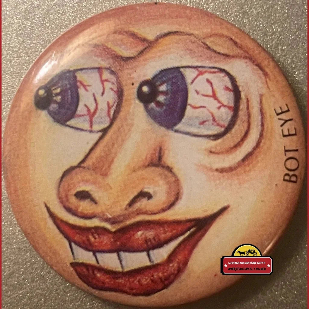 Vintage Bot Eye Pin with cartoon face, bloodshot eyes, and a big grin from the 80s