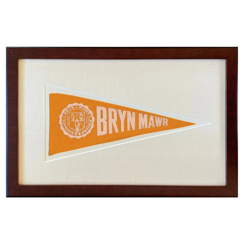 Vintage Bryn Mawr College pennant in orange triangle with white emblem, framed