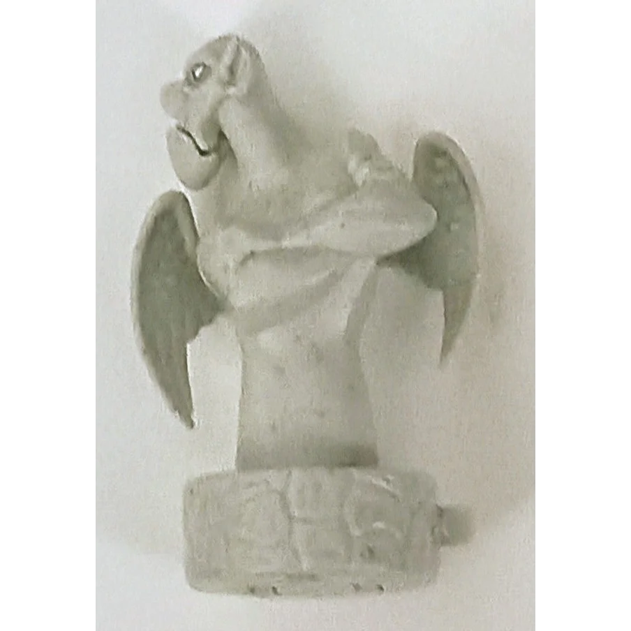 Vintage Burger King Victor gargoyle wind-up toy with gray stone wall ornament, 1996