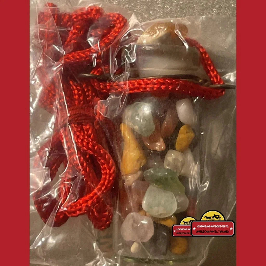 Clear plastic bag with colorful stones and red cord for a vintage chakra necklace