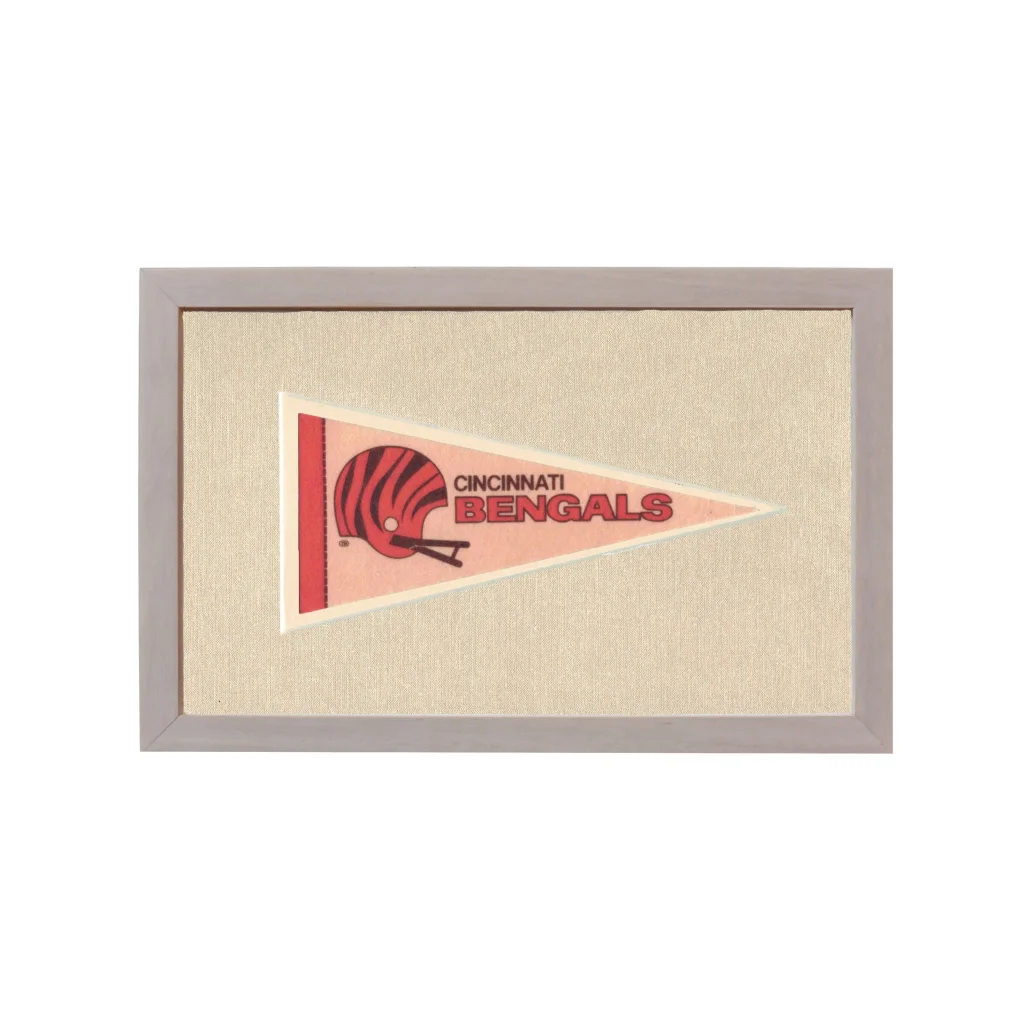 Vintage Cincinnati Bengals pennant with red black helmet on pink background