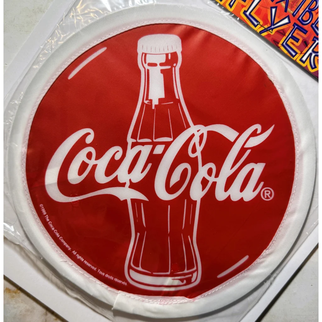 Vintage Coca-Cola Flexible Cloth Frisbee showing NOS soda memorabilia collectible