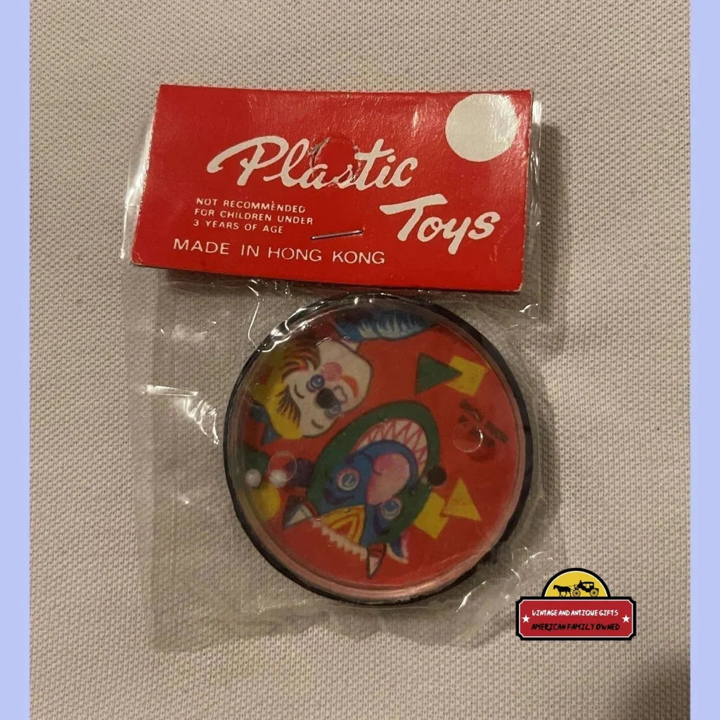 Vintage toy puzzle game featuring colorful clown faces in a fun circular design