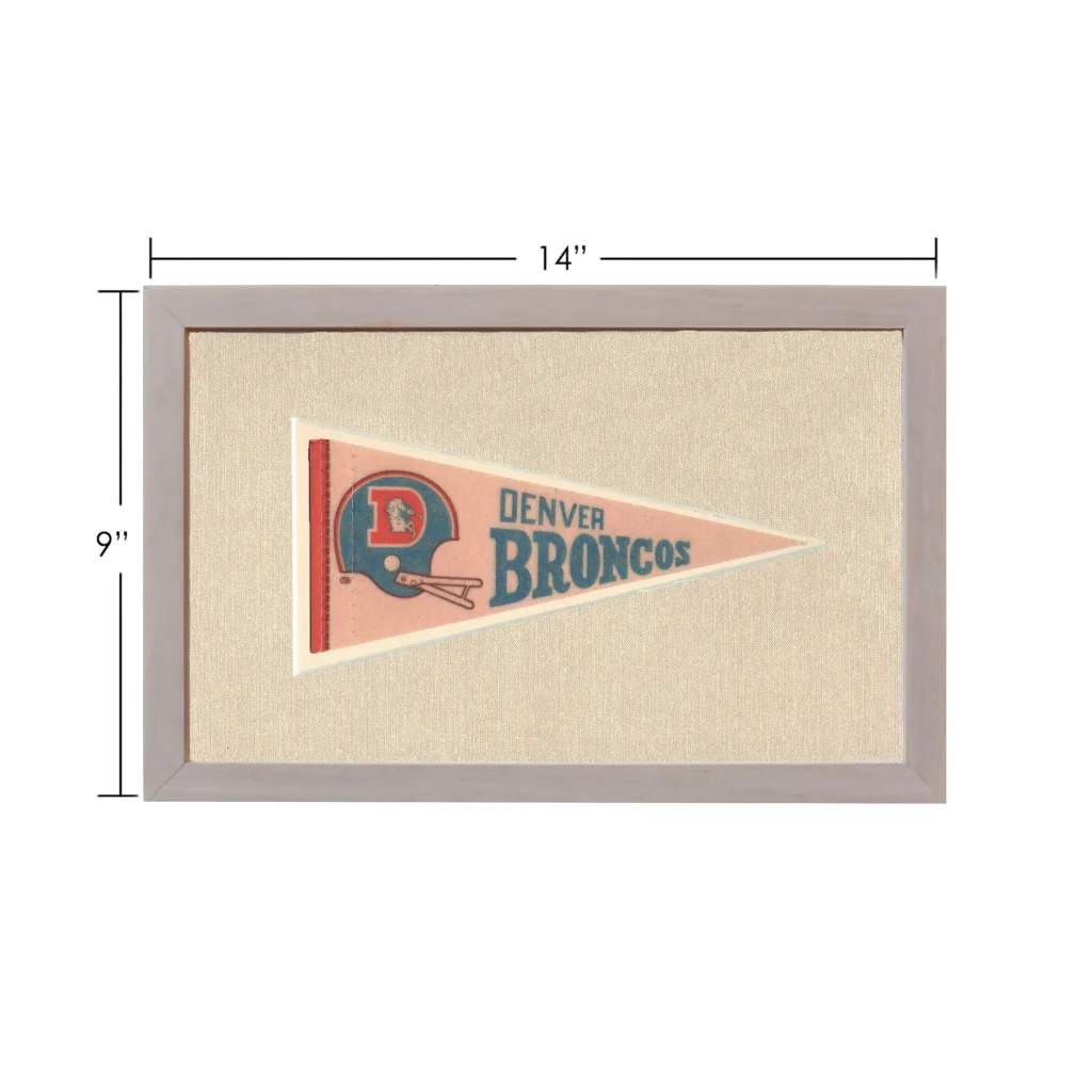 Vintage Denver Broncos pennant framed on pinkish-beige background