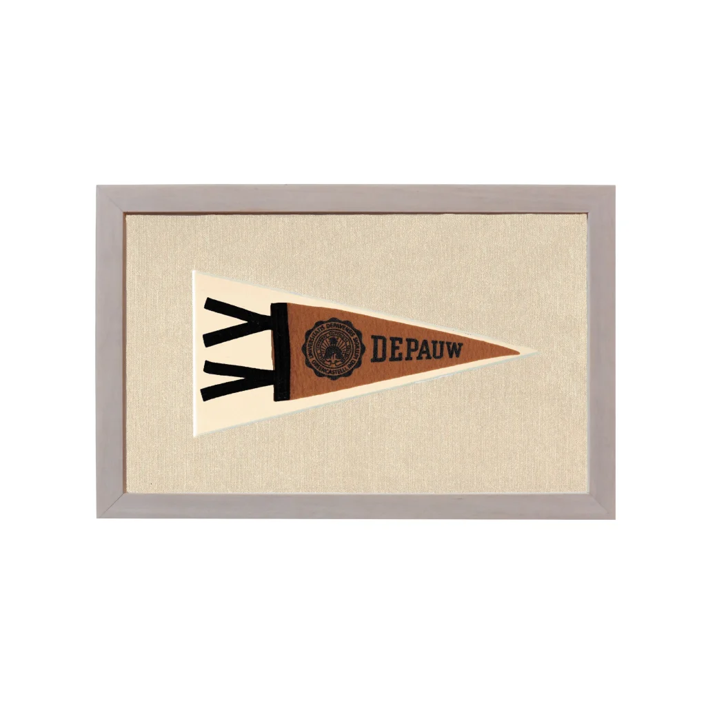 Vintage DePauw University pennant in beige frame on off-white background