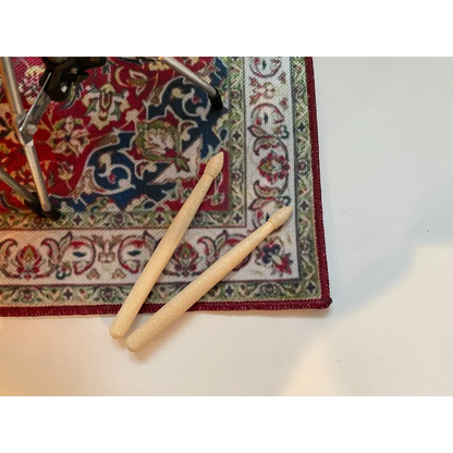 Vintage drum rug with cream knitting needles for scale drum kit display