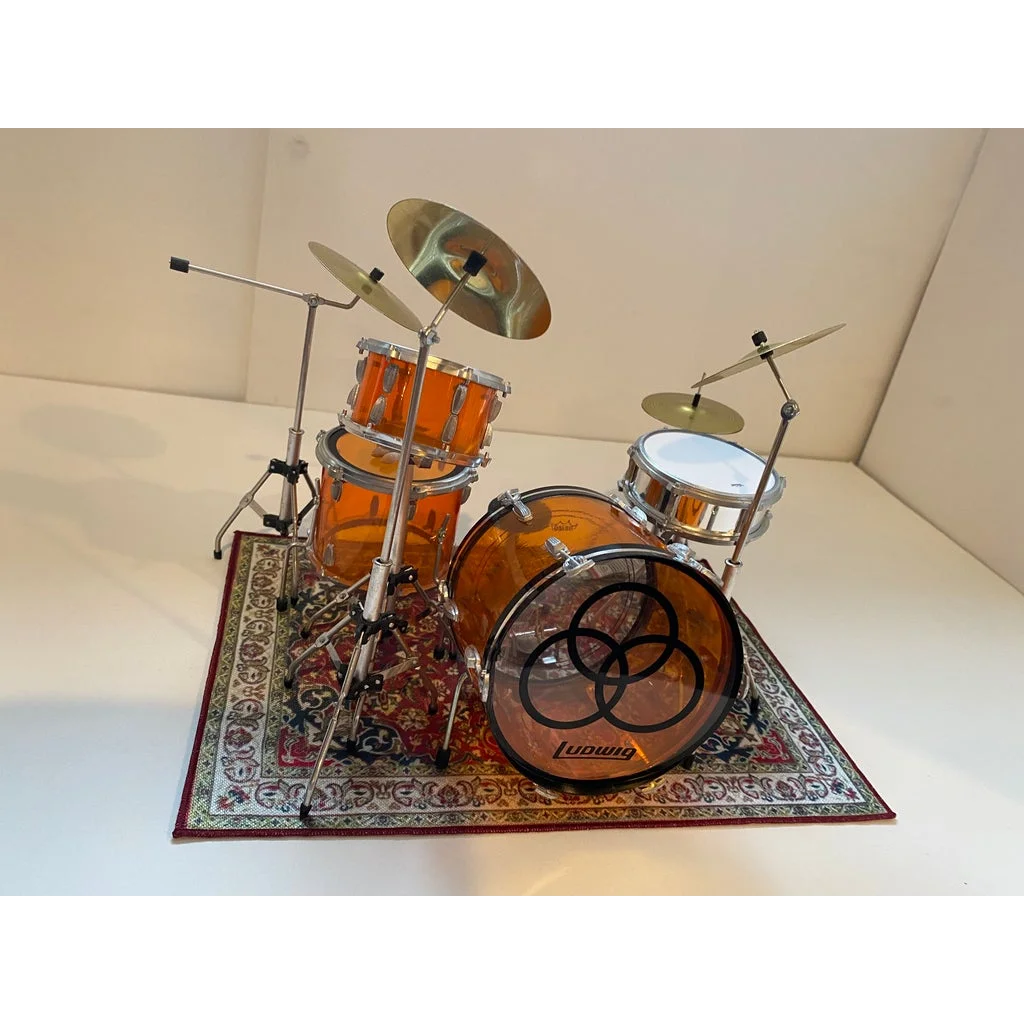 Orange drum kit on vintage drum rug for scale drum kit display