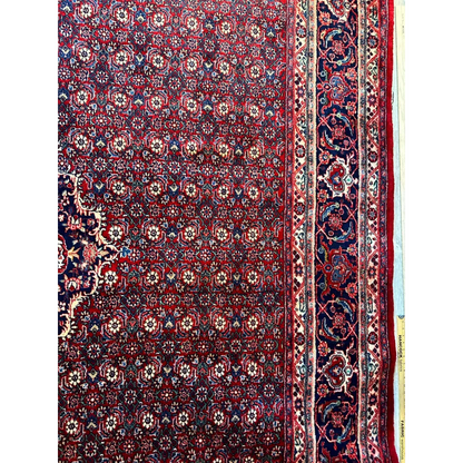 Vintage fine Persian rug in deep red with intricate blue floral patterns