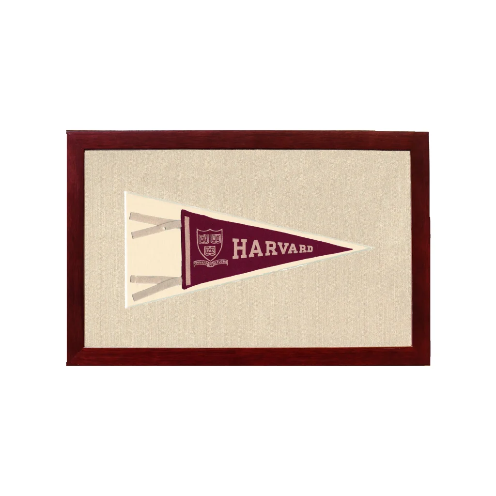 Vintage Harvard pennant in maroon and cream, framed in dark wood