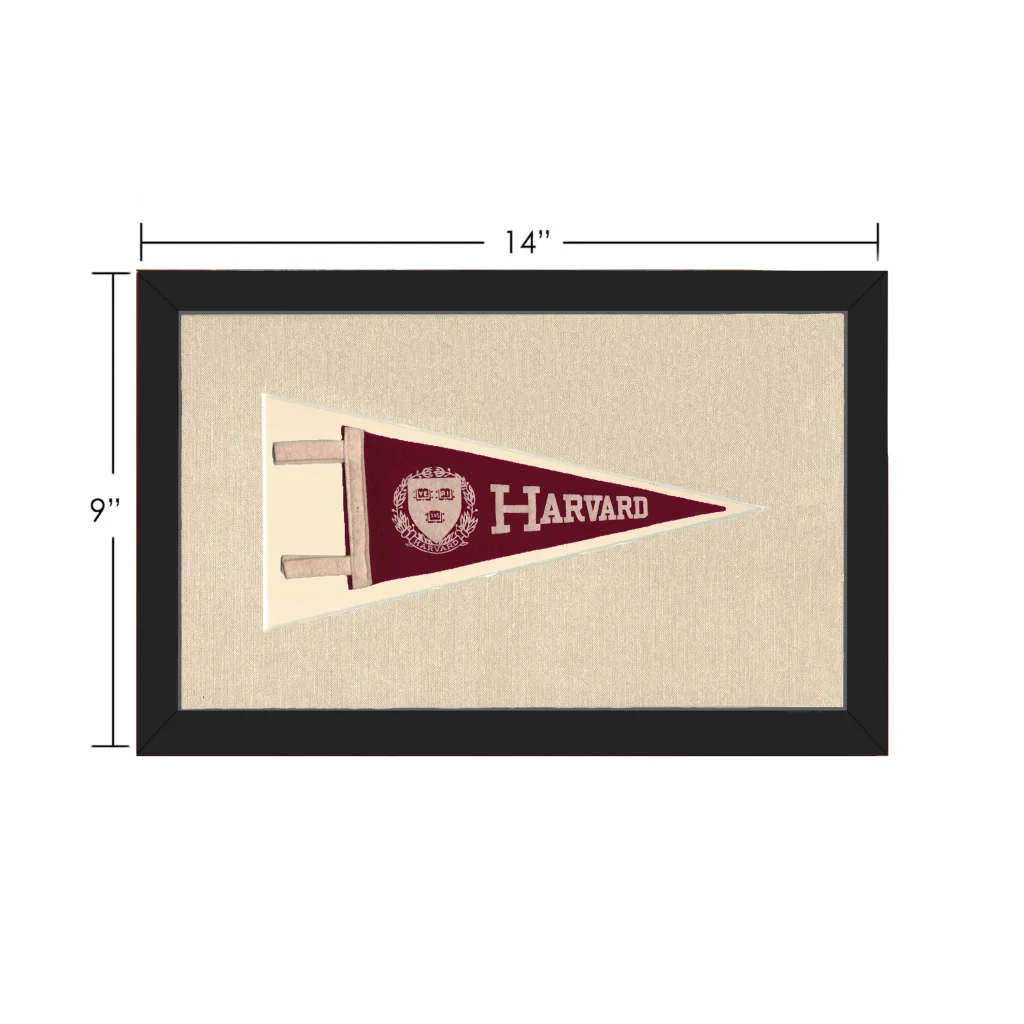 Vintage Harvard pennant in maroon with white lettering and crest, framed