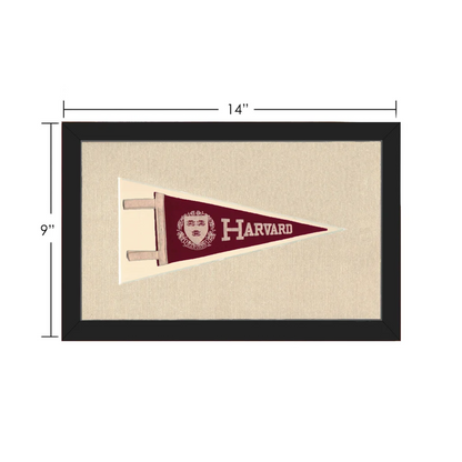 Vintage Harvard pennant in maroon with white lettering and crest, framed