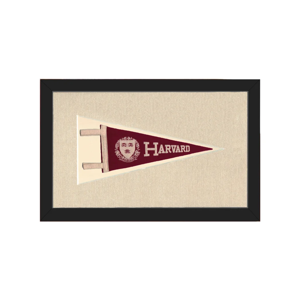 Vintage Harvard pennant in maroon with white lettering and crest, black frame