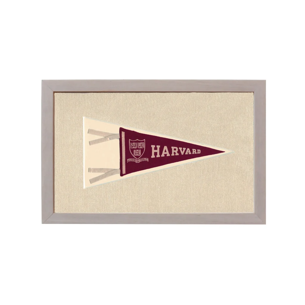 Vintage Harvard pennant in maroon with white lettering and crest, framed