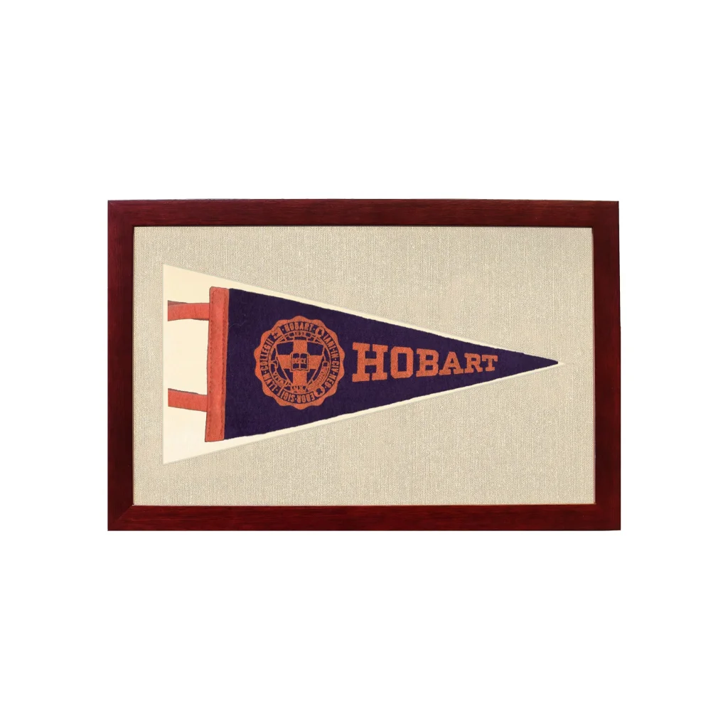 Vintage Hobart College pennant in navy blue frame on beige background