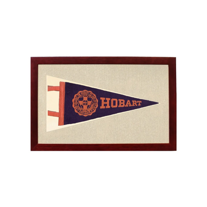 Vintage Hobart College pennant in navy blue frame on beige background