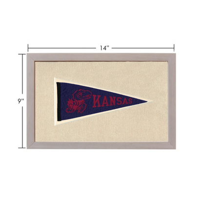Vintage Kansas pennant in navy blue with red embroidered text and mascot, framed