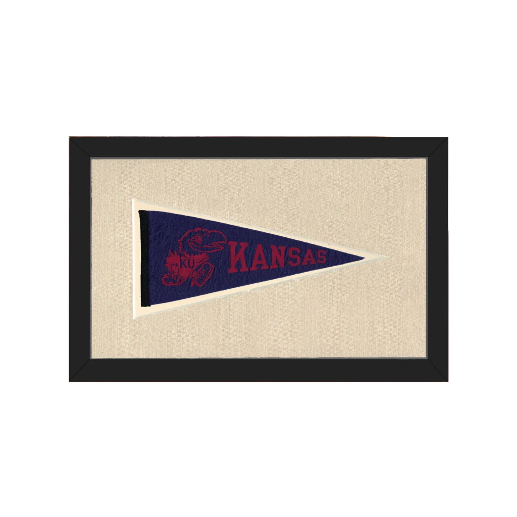 Vintage Kansas pennant in navy blue with red lettering and mascot, framed in black