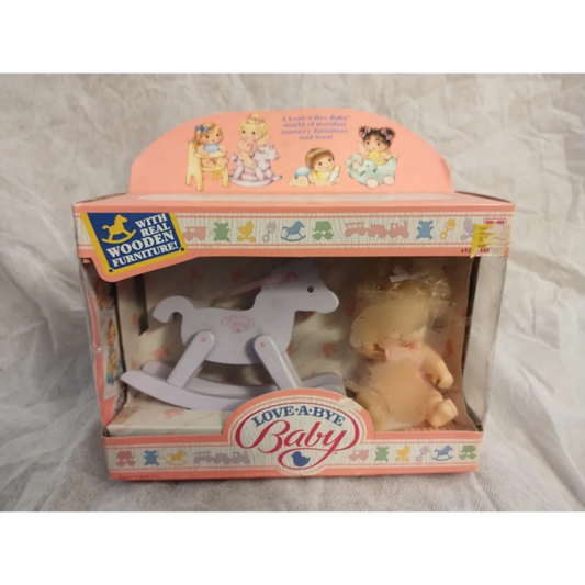Vintage Love A Bye Baby Doll in pink dress with blonde hair and wooden rocking horse