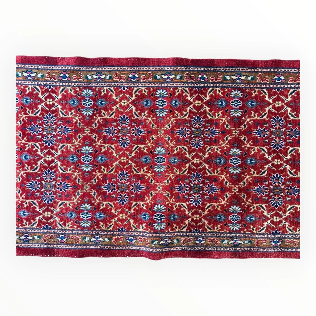 Vibrant rich red vintage Mashhad Persian runner rug with intricate blue and cream floral patterns on cotton foundation
