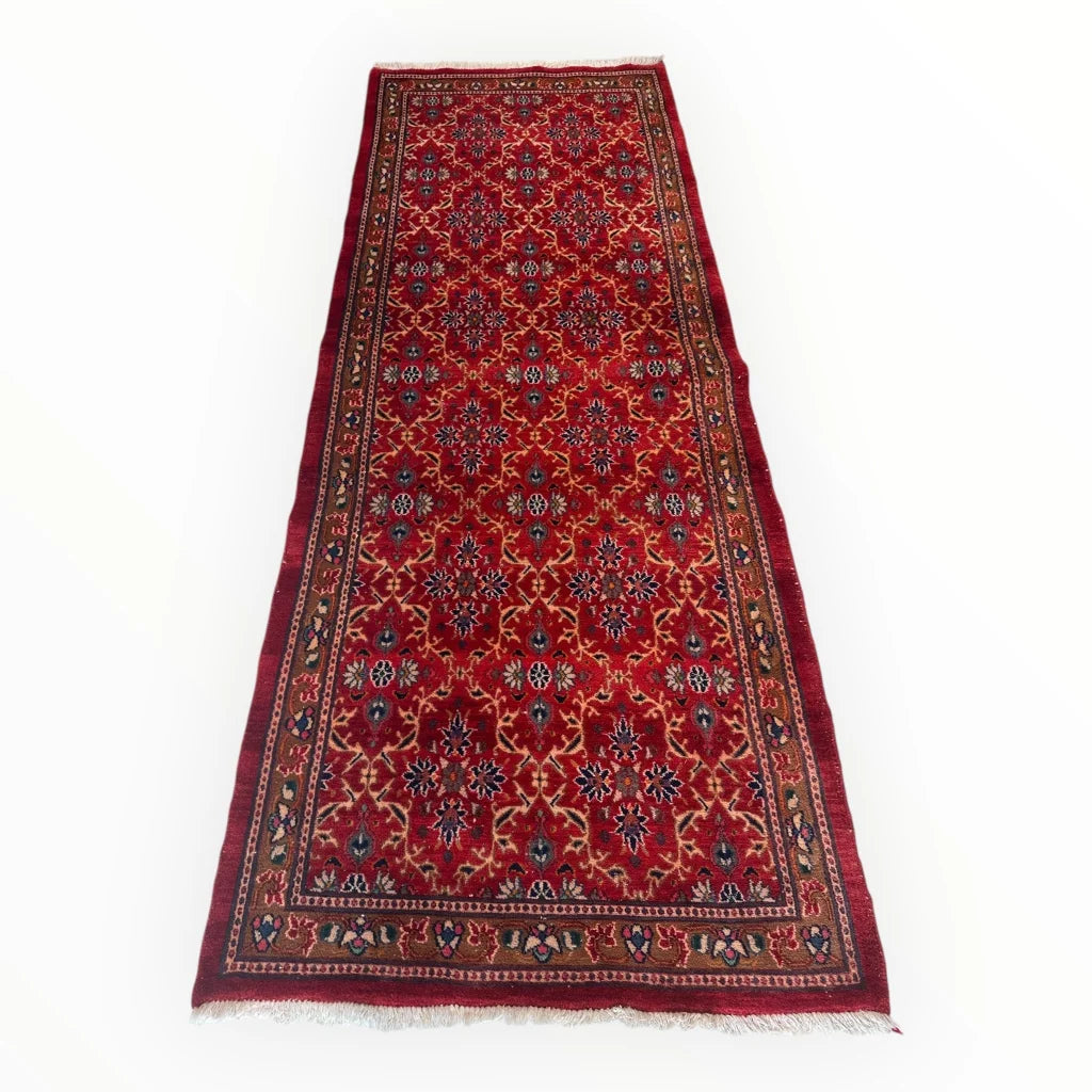 Vintage Mashhad rich red Persian runner rug with floral patterns