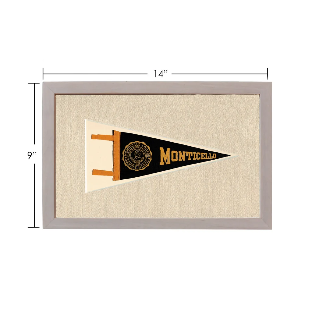 Vintage Monticello College pennant framed in black and gold