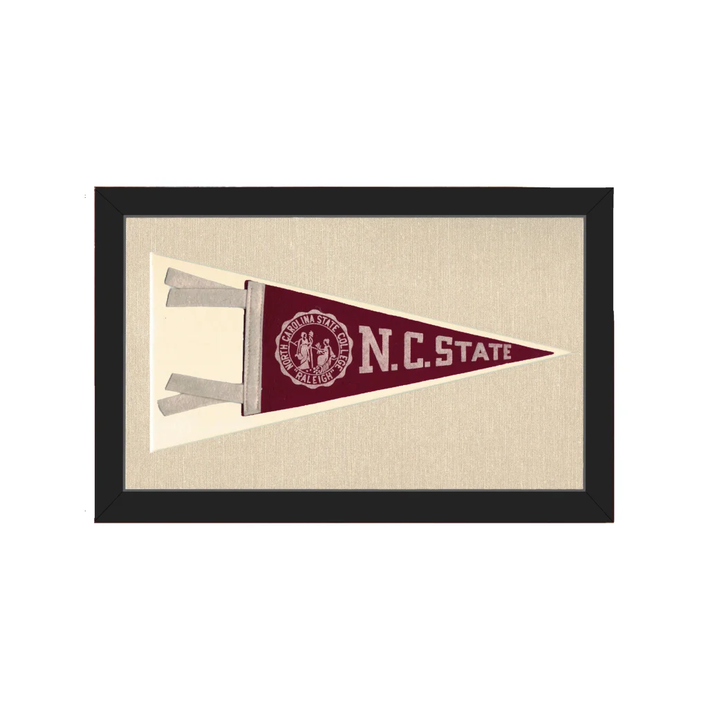 Vintage NC State pennant in maroon and cream, framed in black