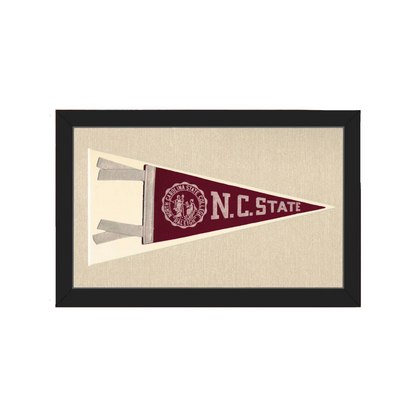 Vintage NC State pennant in maroon and cream, framed in black