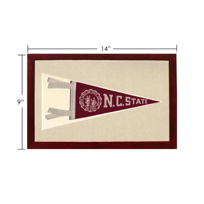 Vintage NC State pennant in maroon and cream, framed in dark wood