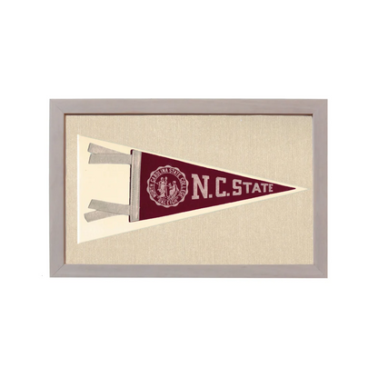 Vintage NC State pennant in maroon and cream, framed in light gray