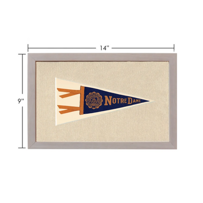 Vintage Notre Dame pennant in navy blue and cream with gold lettering, framed